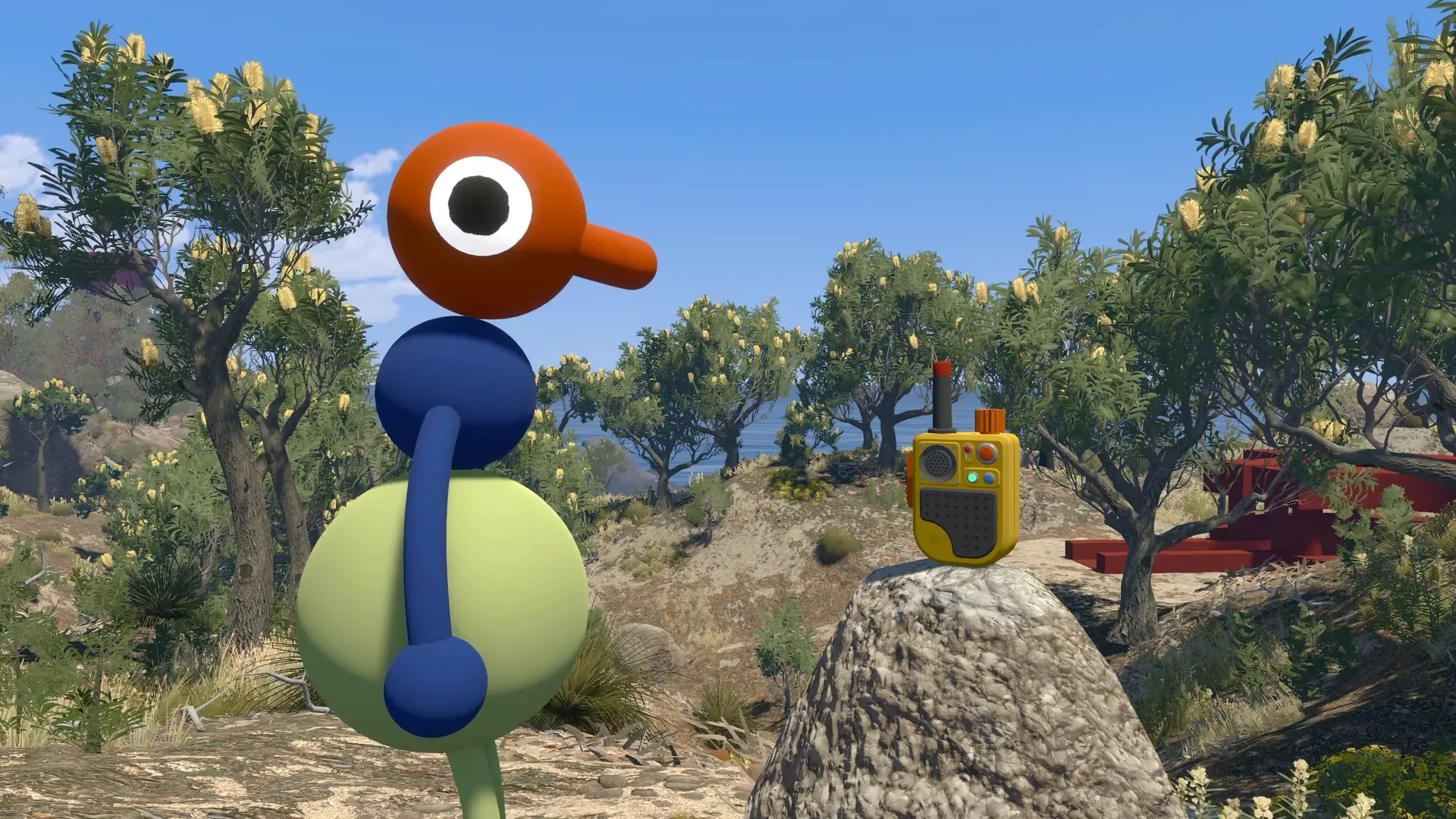 An orange-headed friend beside a handheld radio on a rock.