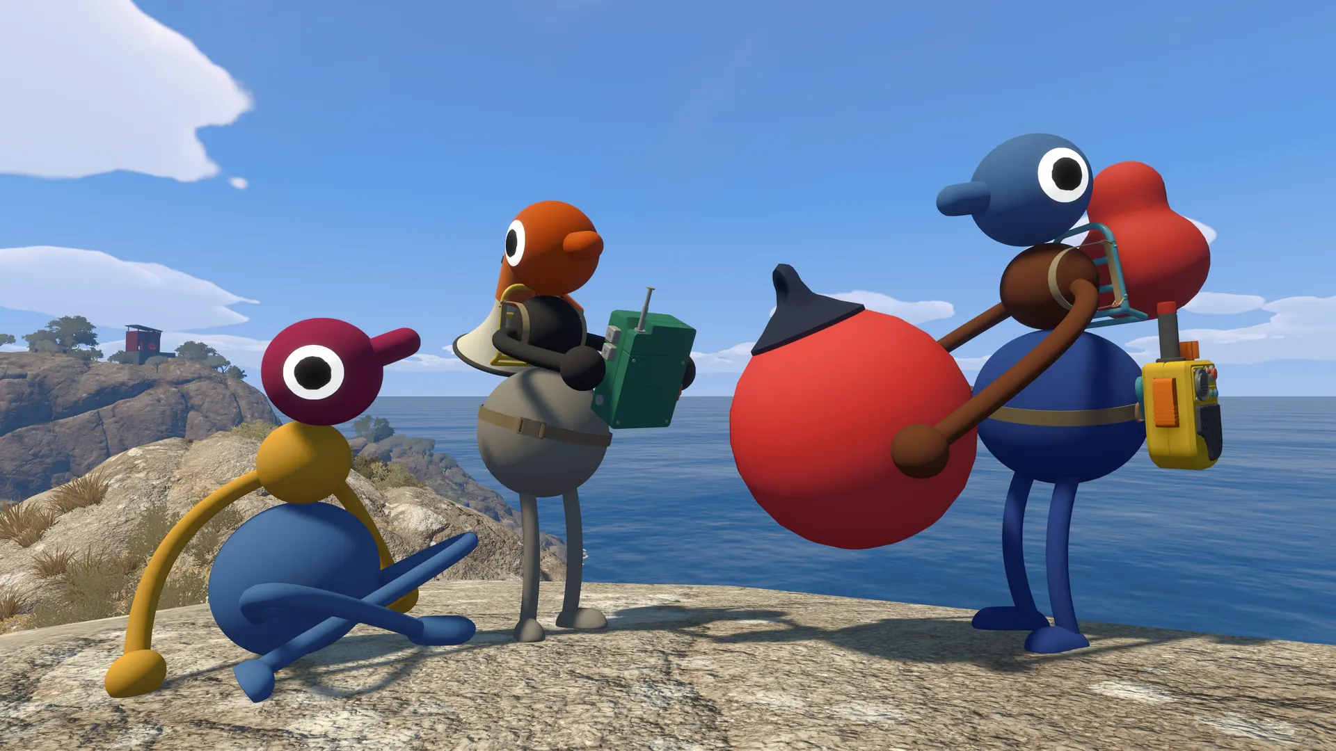 Three friends carrying equipment above a rocky coastline.