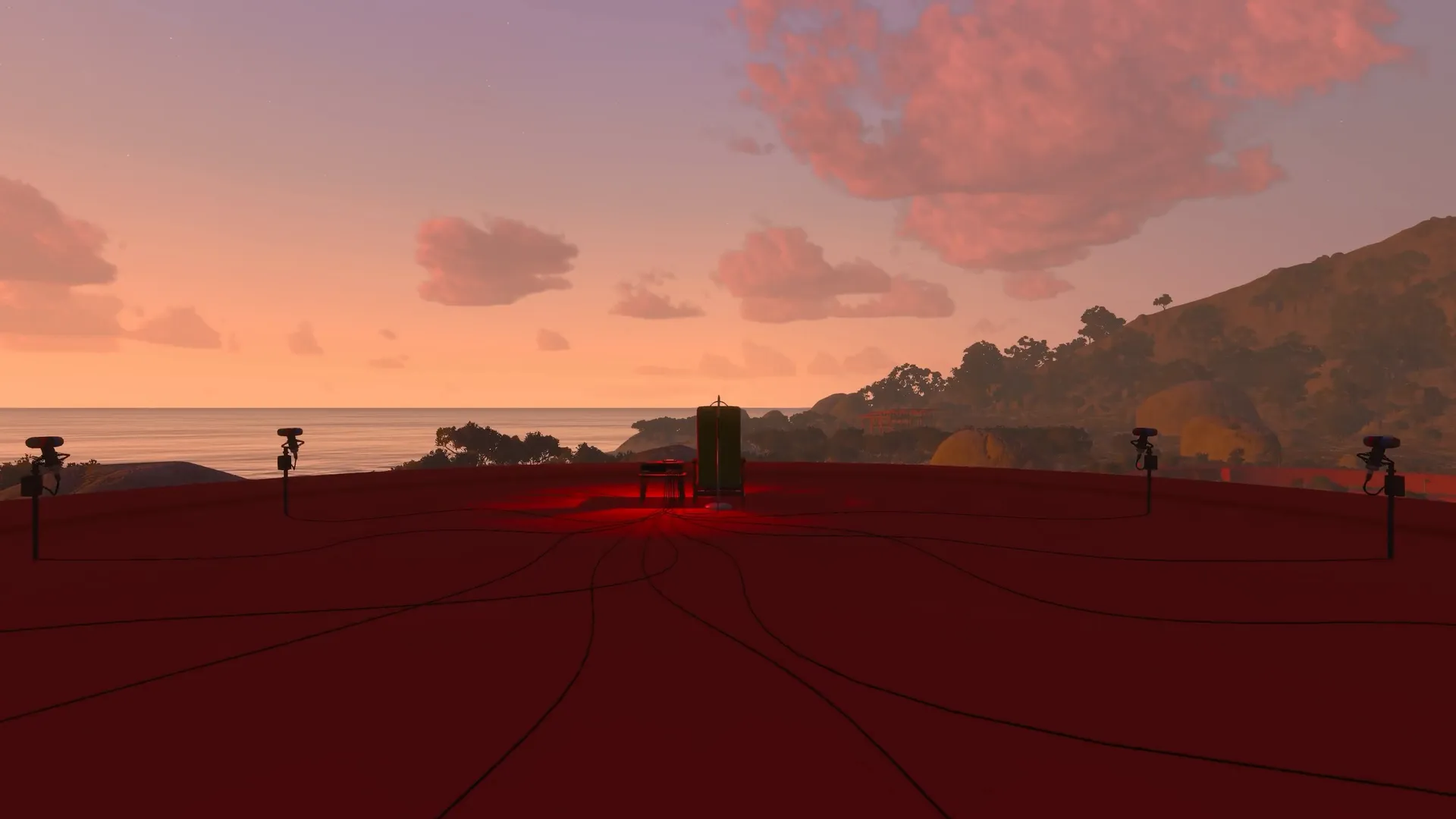 Puzzle equipment on a red platform overlooking the sea at sunset.