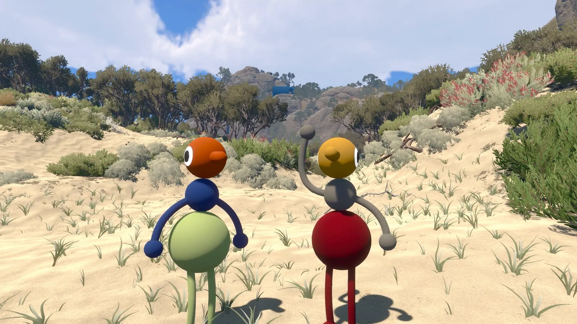 Two friends standing together in a sandy clearing between low rocky hills.